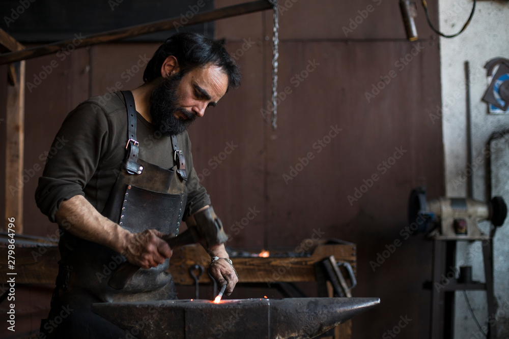 Blacksmith hammering hot iron Blacksmith hammering hot iron