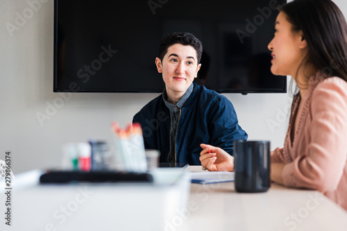 Young businessman looking at colleague