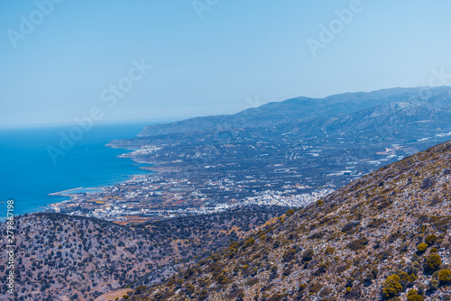 Top view from the autumn mountains to the village of Malia, roads and the nearby villages of the field and the Aegean Sea. Crete, Greece