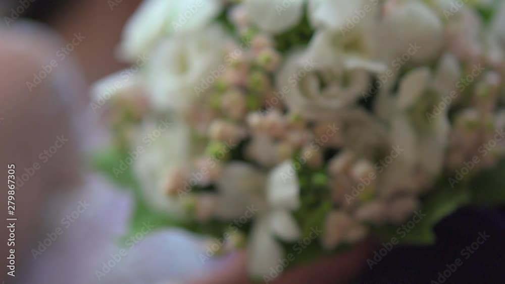 The bridegroom gives her bride a wedding bouquet in the rays of the son and she takes it. The general and detailed plan. Wedding flowers. People. Love The bridegroom gives her bride a wedding bouquet in the rays of the son and she takes it. The general and detailed plan. Wedding flowers. People. Love