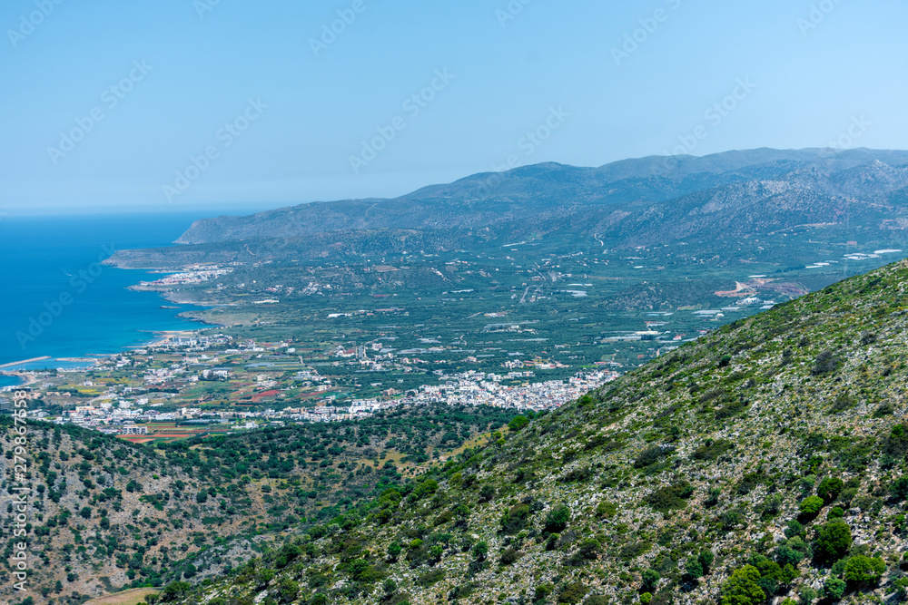 Top view from the mountains to the village of Malia, roads and the nearby villages of the field and the Aegean Sea. Crete, Greece