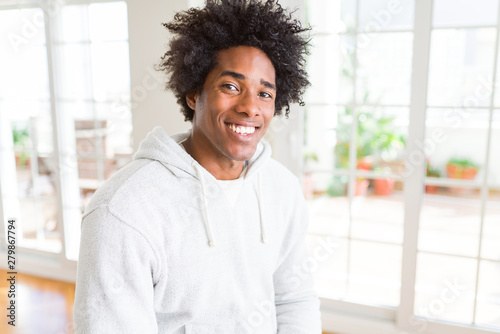 African American man wearing sweatshirt with a happy and cool smile on face. Lucky person. © Krakenimages.com