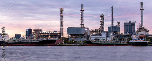 Banner of petroleum oil refinery plant beside river in twilight time. Crude Oil Process machinery