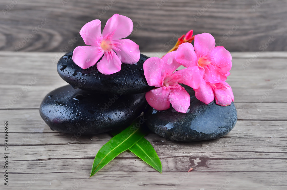 Flower with zen stone on wood background Flower with zen stone on wood background