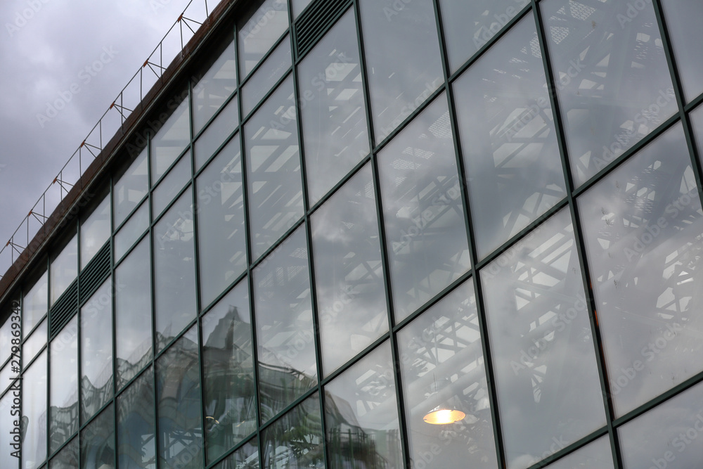 Greenhouse with glass walls and panoramic windows for growing exotic plants in cloudy weather Greenhouse with glass walls and panoramic windows for growing exotic plants in cloudy weather