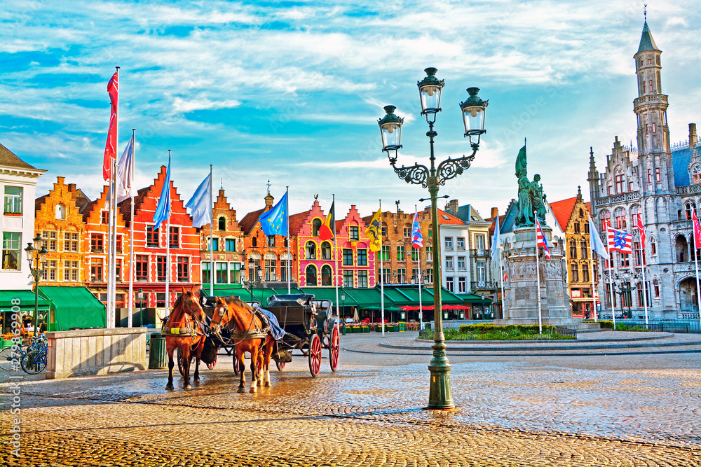 Fototapeta premium Horse carriages on Grote Markt square in medieval city Brugge at morning, Belgium.