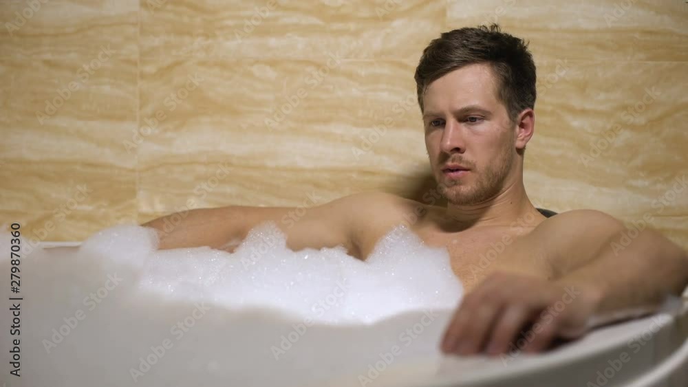 Tensed man taking bath, thinking about work and cant relax, difficult decision Tensed man taking bath, thinking about work and cant relax, difficult decision