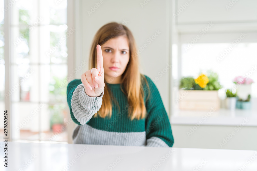 Young beautiful plus size woman wearing casual striped sweater Pointing with finger up and angry expression, showing no gesture Young beautiful plus size woman wearing casual striped sweater Pointing with finger up and angry expression, showing no gesture