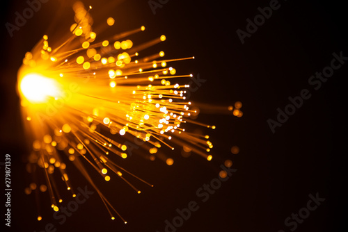 Fiber optic light abstract bokeh background with warm color. Out of focus.