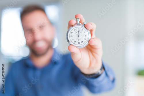 Handsome man showing stopwatch