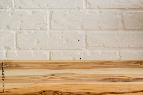 Wooden surface on a white brick background