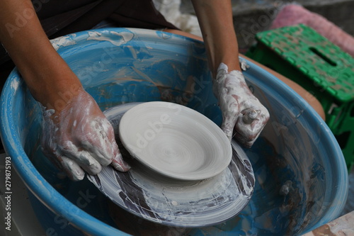 Master of ceramics. We work with clay. The master ceramist teaches the student. Craftsman hands sculpts clay