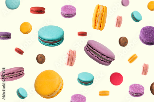 Falling macaroons on light yellow background. Seamless texture or pattern