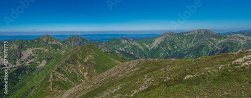 Panoramic view from Baranec peak on Western Tatra mountains or Rohace panorama. Sharp green mountains - ostry rohac, placlive and volovec with hiking trail on ridge. Summer blue sky white clouds. photo