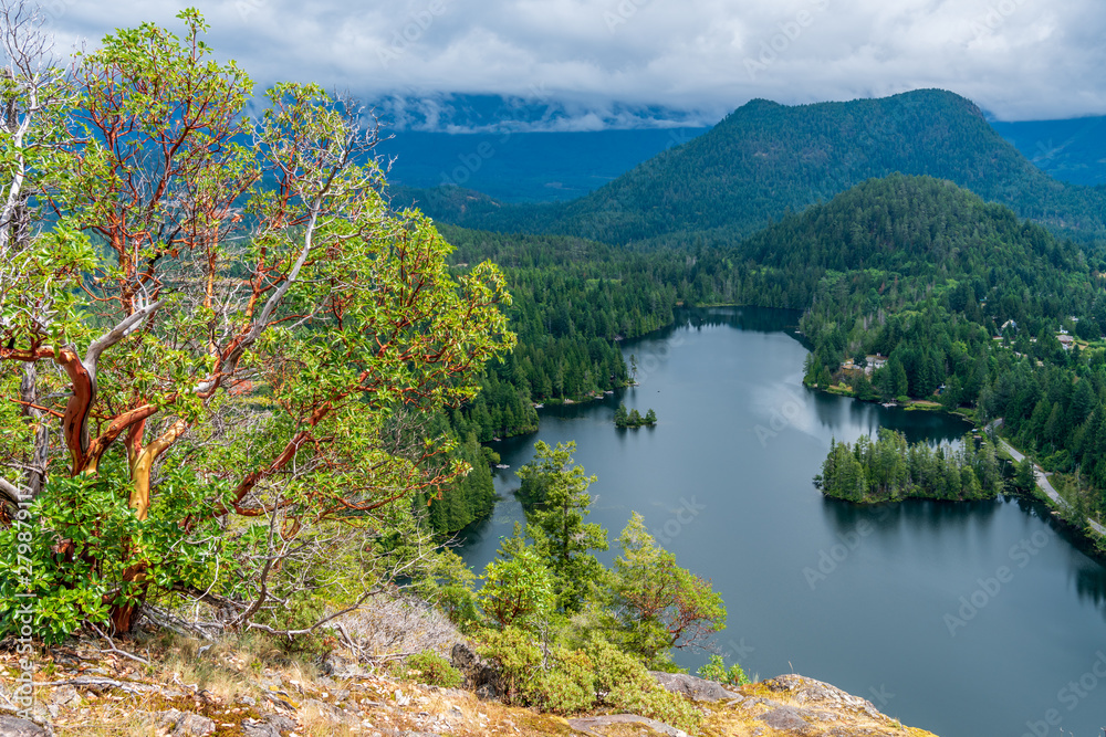 Fototapeta premium Aerial View at Mountain Lake with Dramatic Clouds in British Columbia, Canada.