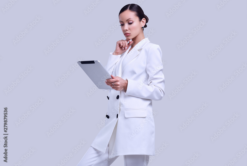 Gorgeous latin women in fashion white suit with digital tablet Gorgeous latin women in fashion white suit with digital tablet