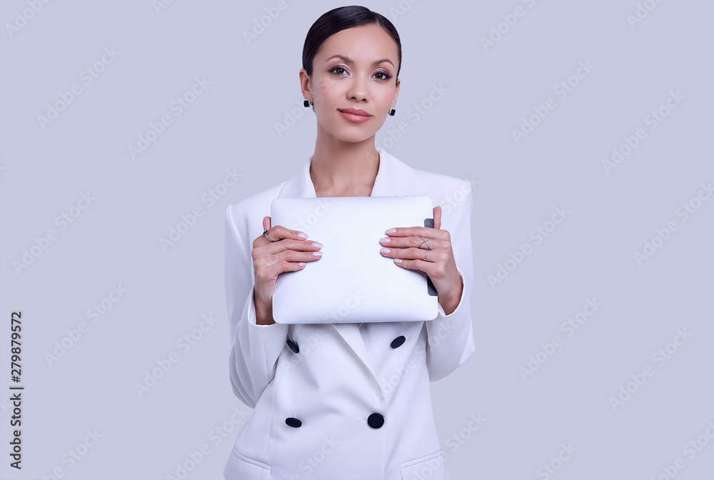 Gorgeous latin women in fashion white suit with digital tablet Gorgeous latin women in fashion white suit with digital tablet