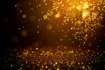 Golden abstract bokeh on black background.