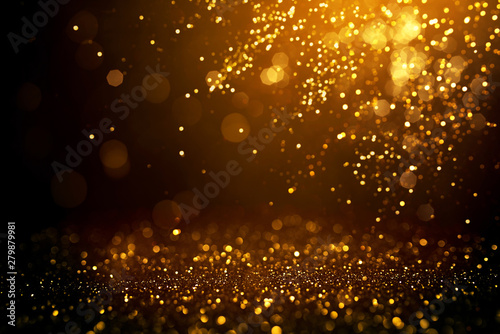 Golden abstract bokeh on black background.