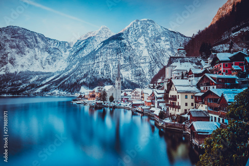 Typical village called Hallstatt con the Hallstatter see at sunrise with the houses reflecting in the lake photo