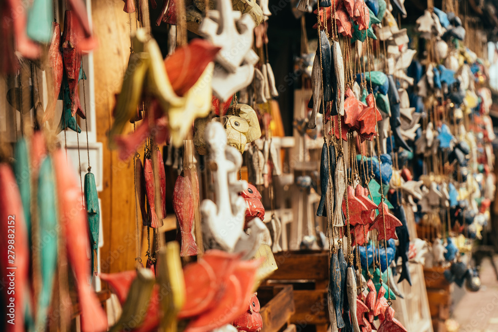 Fototapeta premium Handmade wooden mobile souvenirs hanging in Bali shop