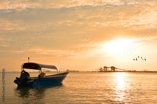 Fisherman boat with sunset background © shahrilkhmd