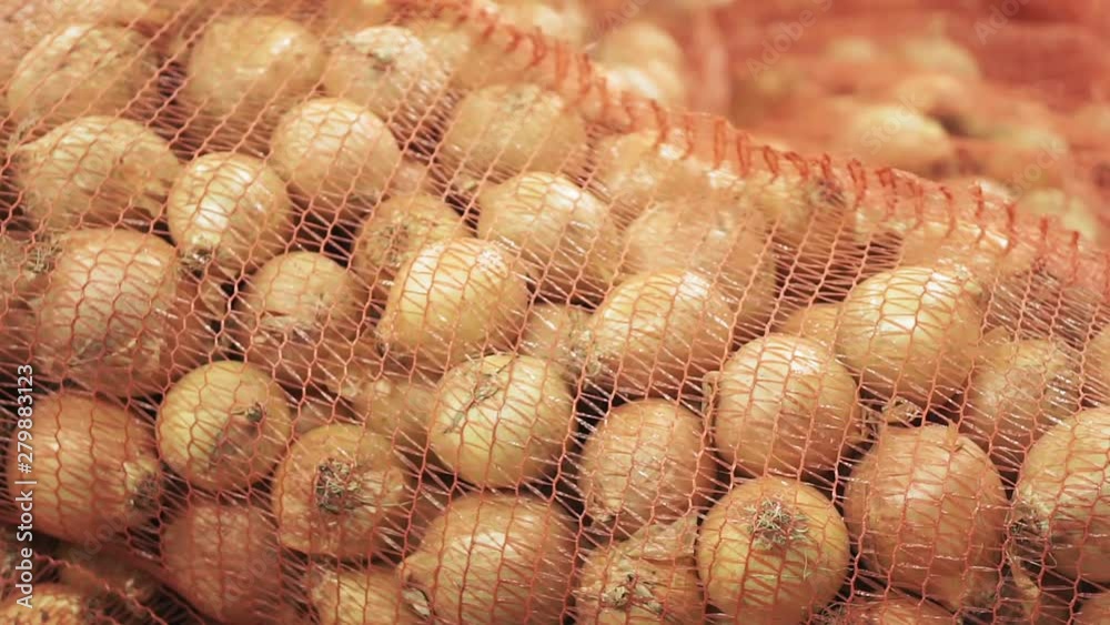 sale of fresh onions in a bag on the market counter close-up sale of fresh onions in a bag on the market counter close-up