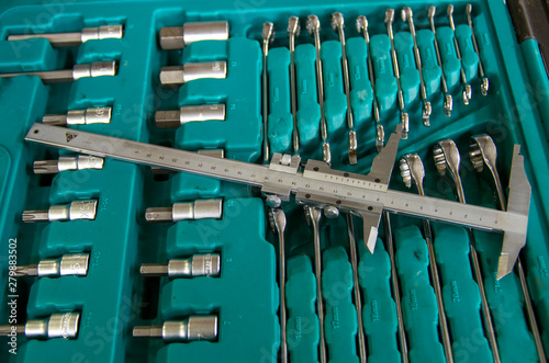 A set of tools  wrenches  caliper  in a green box  ready to work.
