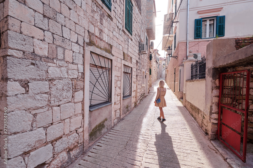 Enjoying vacation in Croatia. Young traveling woman walking on Split Old Town.