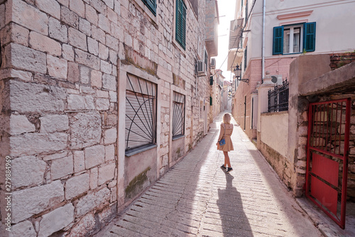 Enjoying vacation in Croatia. Young traveling woman walking on Split Old Town.