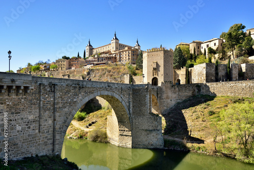 The Puente de Alcantara (Alcantara bridge) over the Tagus river, a roman bridge that was the obligatory entry for all pilgrims in the Middle Ages. A Unesco World Heritage Site, Toledo. Castilla la Mancha, Spain photo