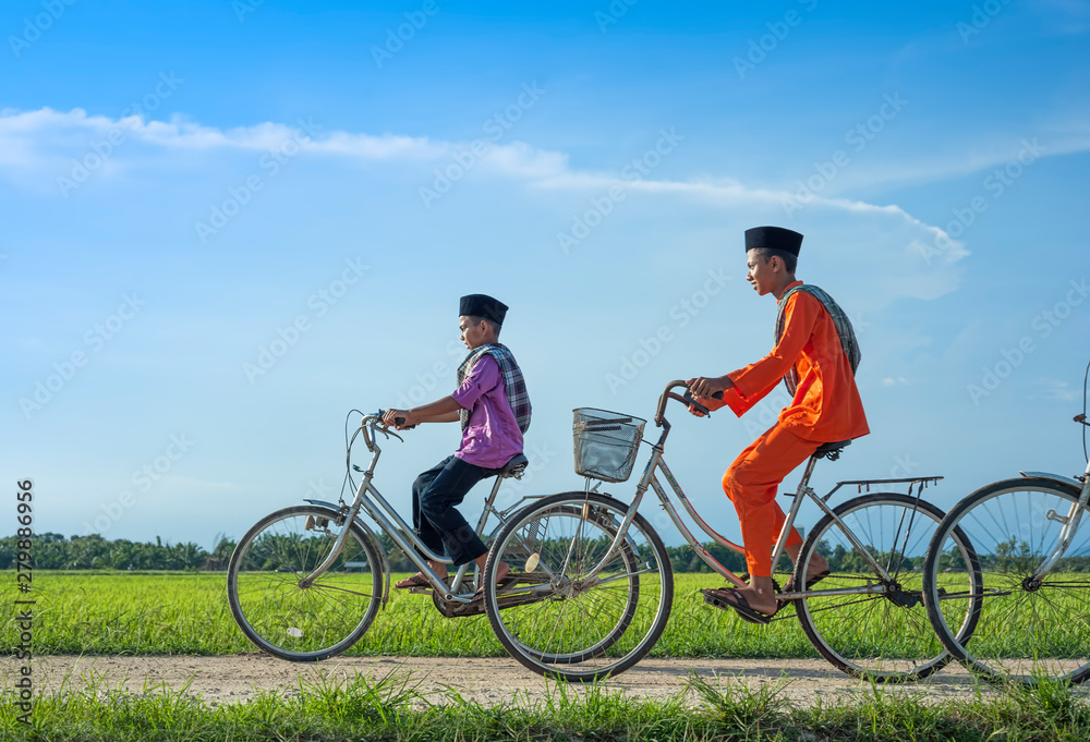 happy young local boy riding old bicycle at paddy field happy young local boy riding old bicycle at paddy field
