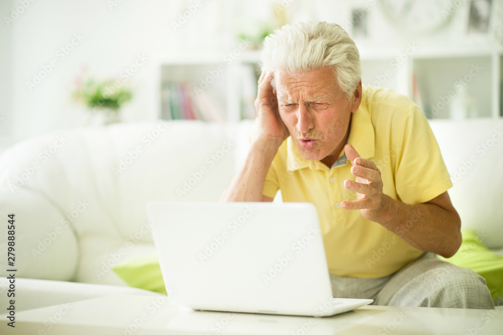 Portrait of emotional senior man using laptop Portrait of emotional senior man using laptop