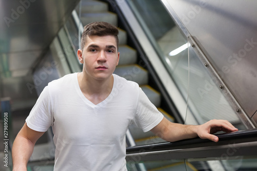 Man on subway station escalator