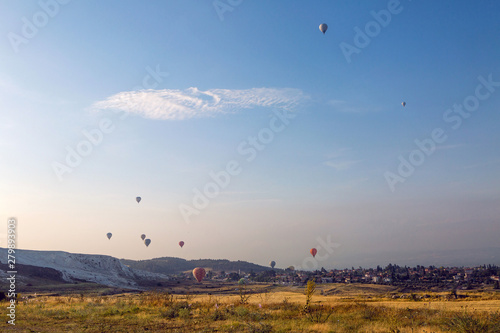 group of flying multicolored hot balloons early morning