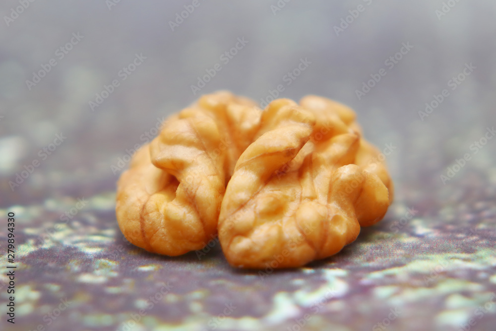 Walnuts on the background imitating the old peeling paint. Walnuts on the background imitating the old peeling paint.