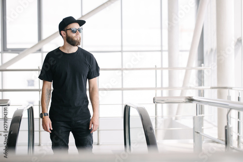 Wallpaper Mural Hipster handsome male model with beard wearing black blank t-shirt with space for your logo or design in casual urban style Torontodigital.ca