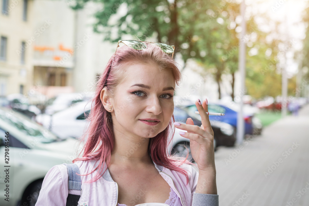 Beautiful young woman with cigarette and drinking coffee