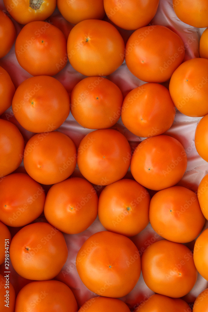 fresh orange tomatoes on the market
