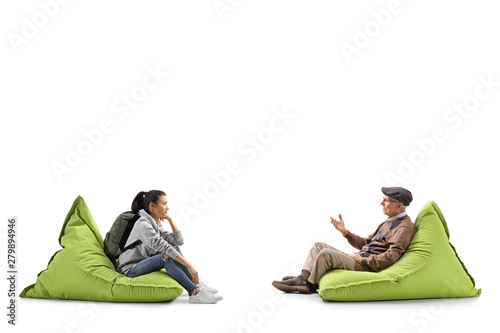 Female student and a senior man sitting on bean bags and talking © Ljupco Smokovski