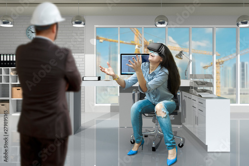The boss looks at the girl in the virtual reality headset
