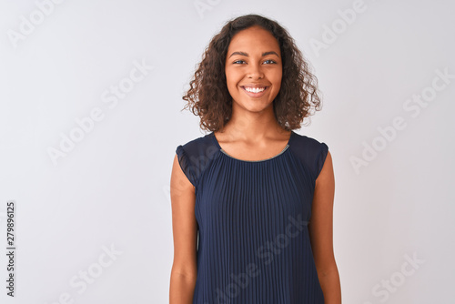 Young brazilian woman wearing blue dress standing over isolated white background with a happy and cool smile on face. Lucky person.