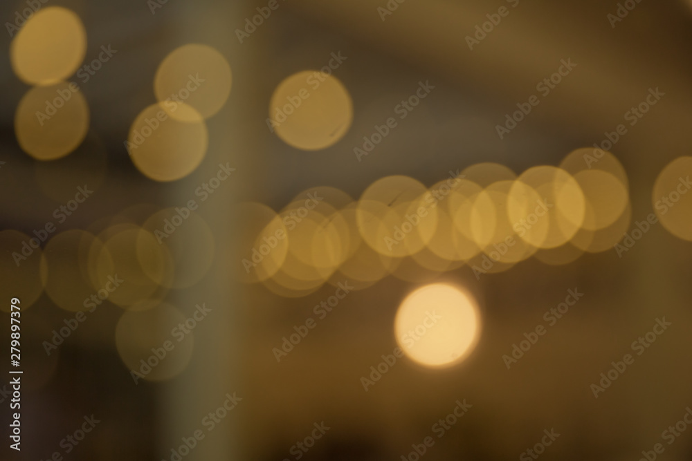 Fototapeta premium Yellow lights bokeh texture. Christmas lights blured .Smooth backgrounds, brightly glowing lights and evening glory, evening lights . Abstract circular bokeh, blured yellow light for background .