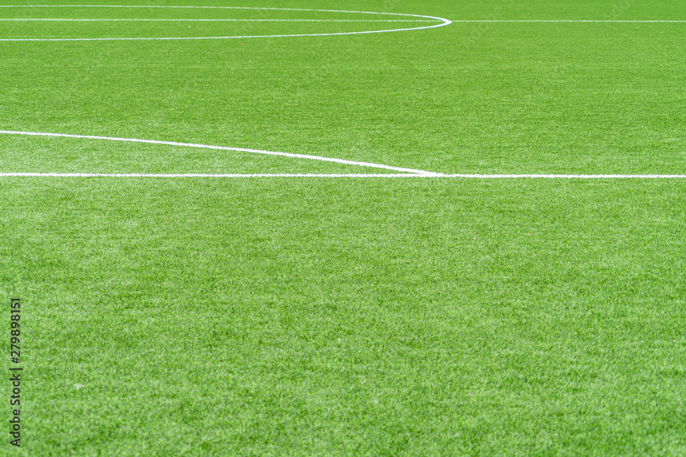 Green artificial grass soccer sports field with white stripe line