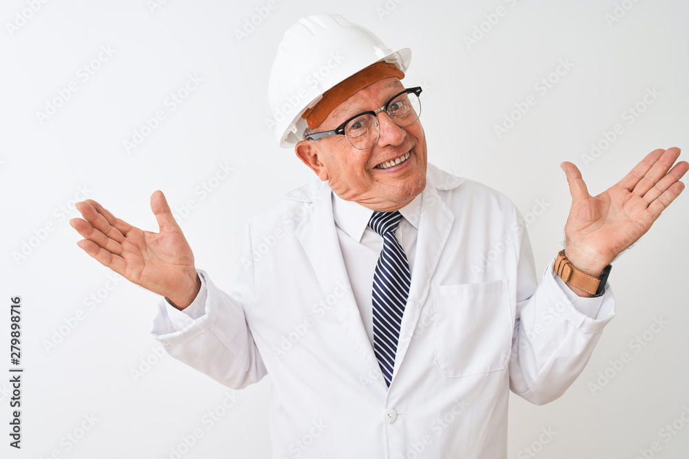 Senior grey-haired engineer man wearing coat and helmet over isolated white background clueless and confused expression with arms and hands raised. Doubt concept.