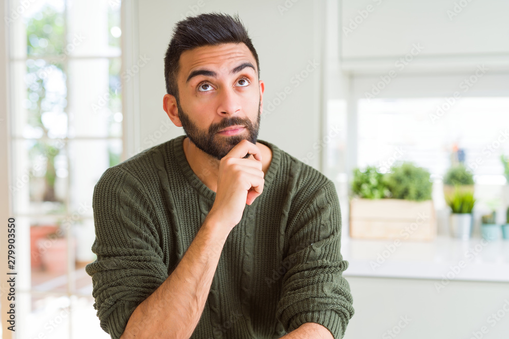 Plakat Handsome man thinking confused about doubt, questioning an idea