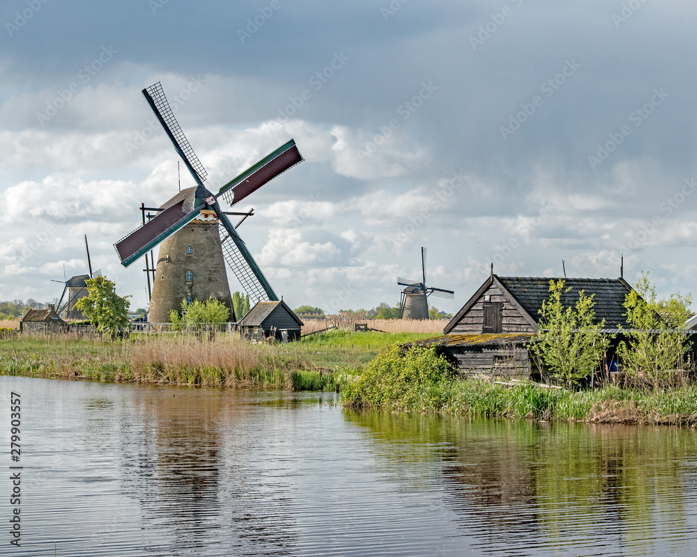 Windmills and a dilapidated shed along the canals of Kinderdijk, Holland, Netherlands