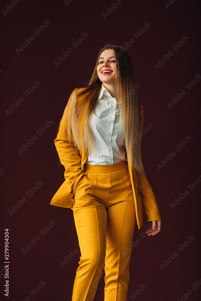 beautiful girl in a yellow suit smiles. casual clothes for busi beautiful girl in a yellow suit smiles. casual clothes for busi