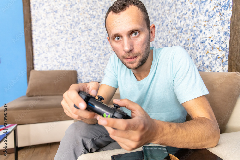 gambling young man with a joystick playing a video game gambling young man with a joystick playing a video game