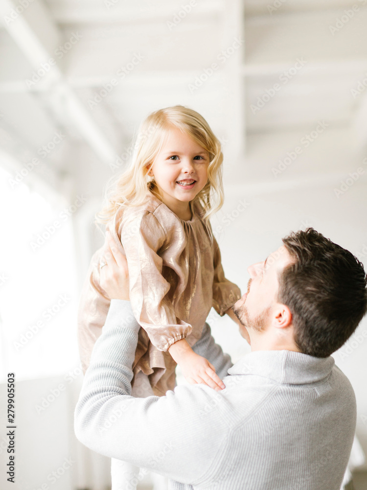 Mid adult man lifting his daughter Mid adult man lifting his daughter